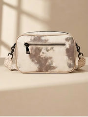 A back side of rectangular bag with a beige and brown tie-dye pattern, featuring a zip pocket and a matching patterned shoulder strap displayed.