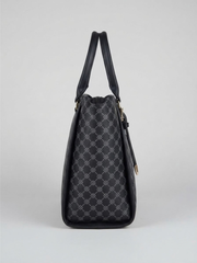 Side angle profile of the structured black tote bag displaying its gusset width and upright dual handles.