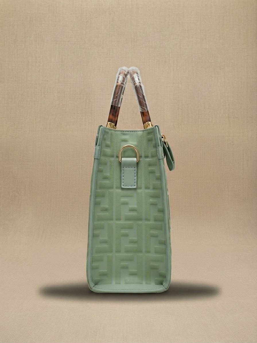 Side view of the sage green Fendi tote bag showing the side hardware and structured profile.