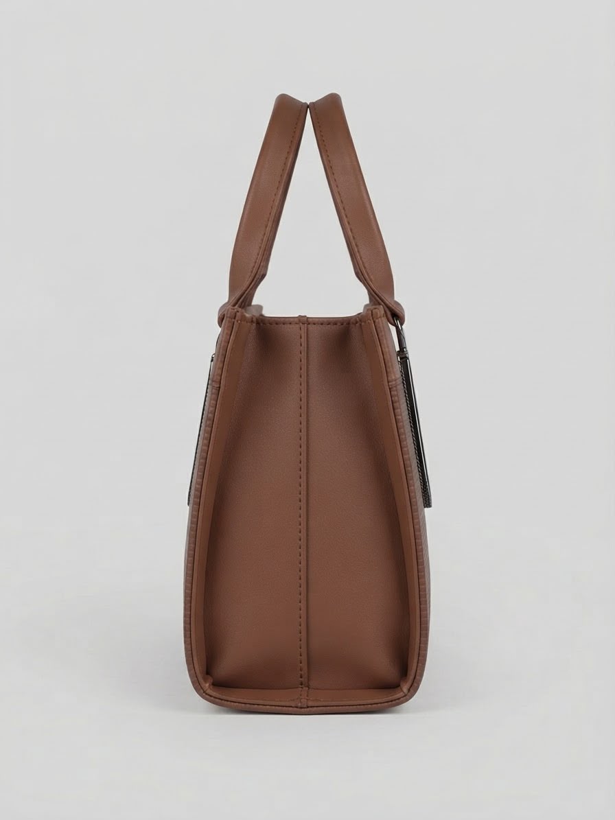 A side profile view showing the depth of the brown structured handbag.
