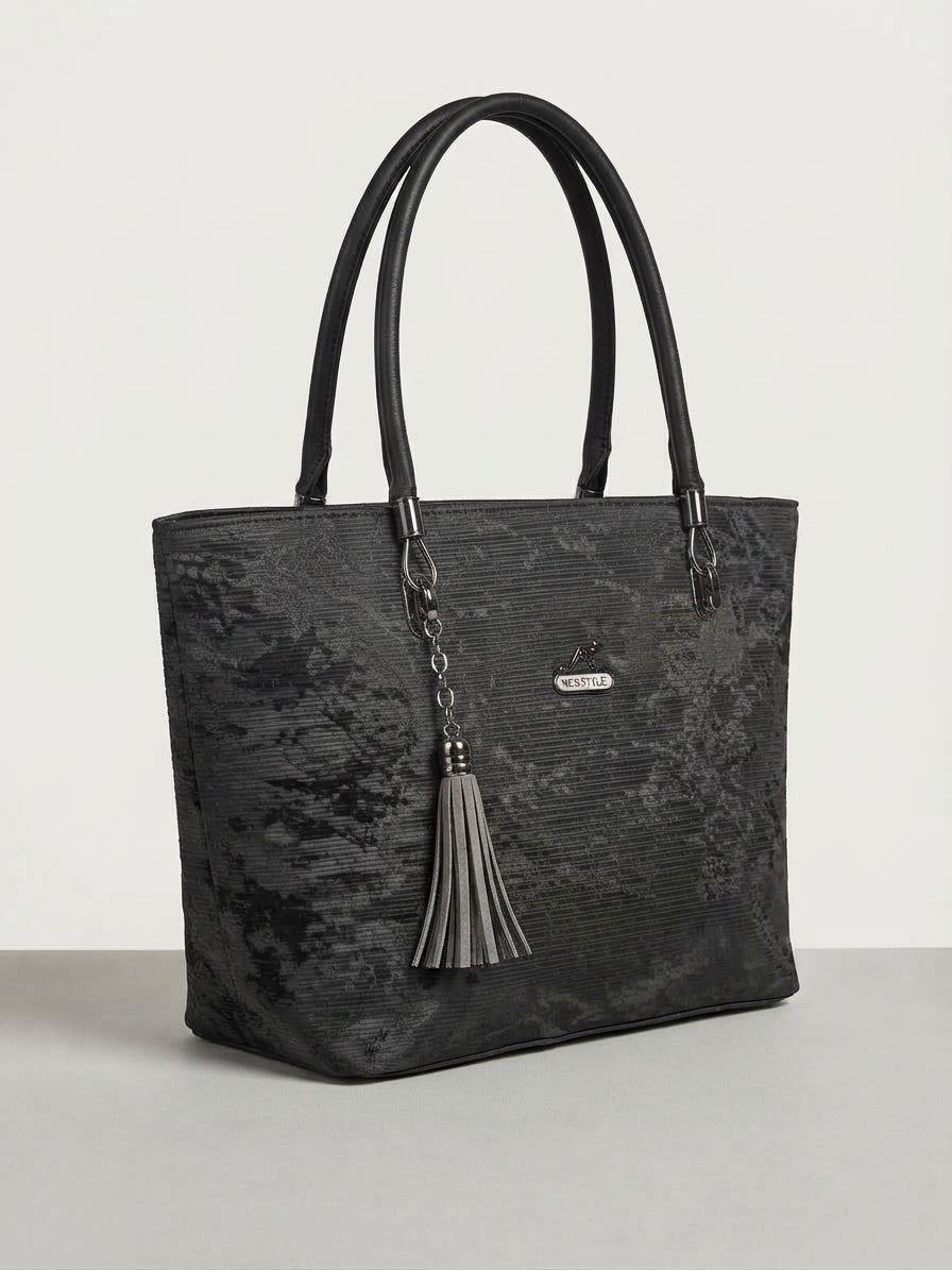 A three-quarter view of the same charcoal grey tote bag on a white background.
