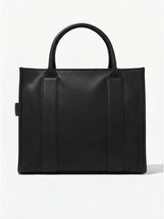 Back view of the solid black leather tote handbag showcasing clean structural stitching and dual top handles against a white background.