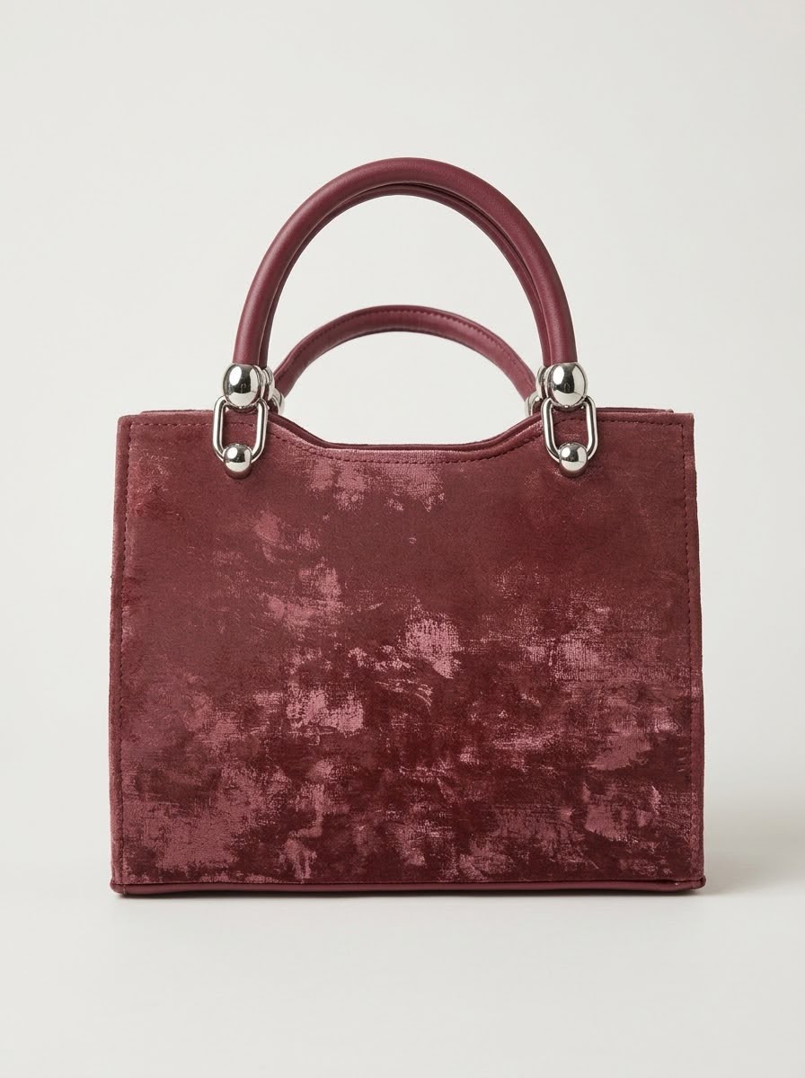 Black view of a burgundy velvet handbag.
