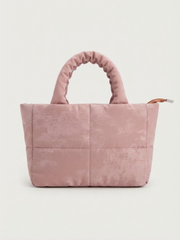 Back view of the pink quilted tote bag showing the clean, stitched pattern and top handle.