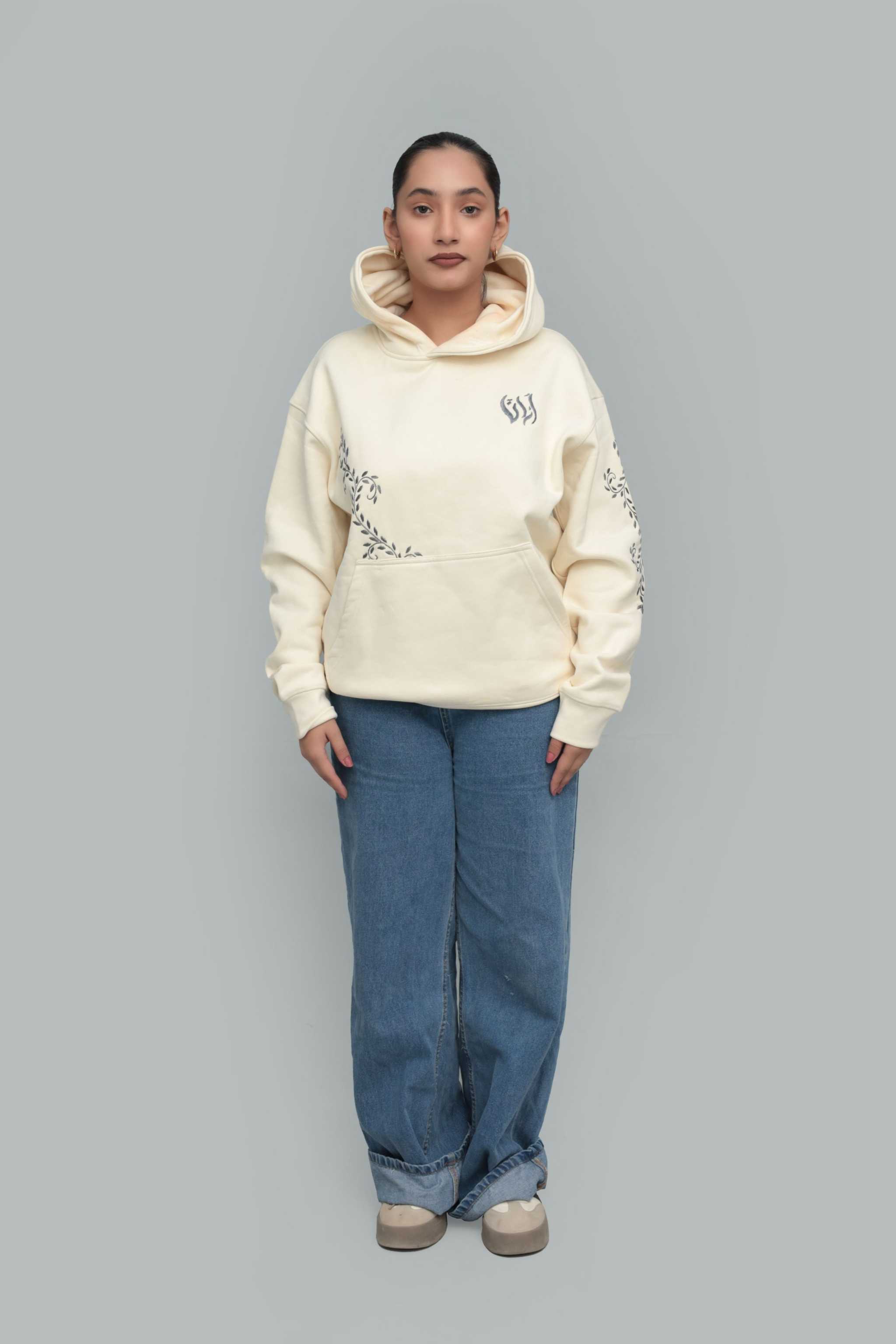premium cream oversized hoodie in soft fleece with floral embroidery on sleeves, a minimal chest motif, and a kangaroo pocket