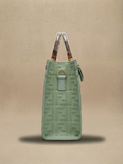 Side view of the sage green Fendi tote bag showing the side hardware and structured profile.
