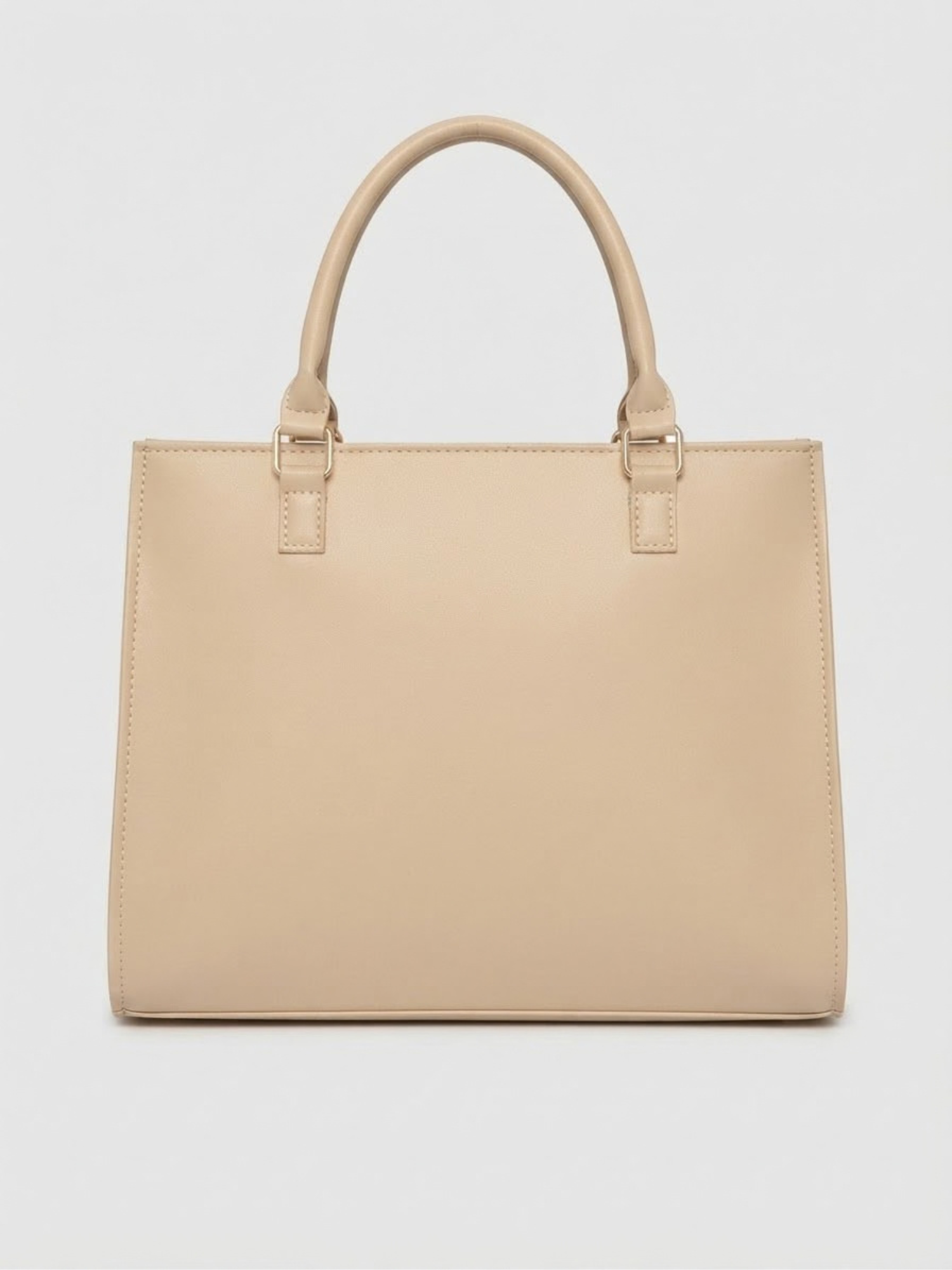 Back view of the solid beige structured handbag by Zaroons London displaying clean vegan leather craftsmanship and top handle attachments.