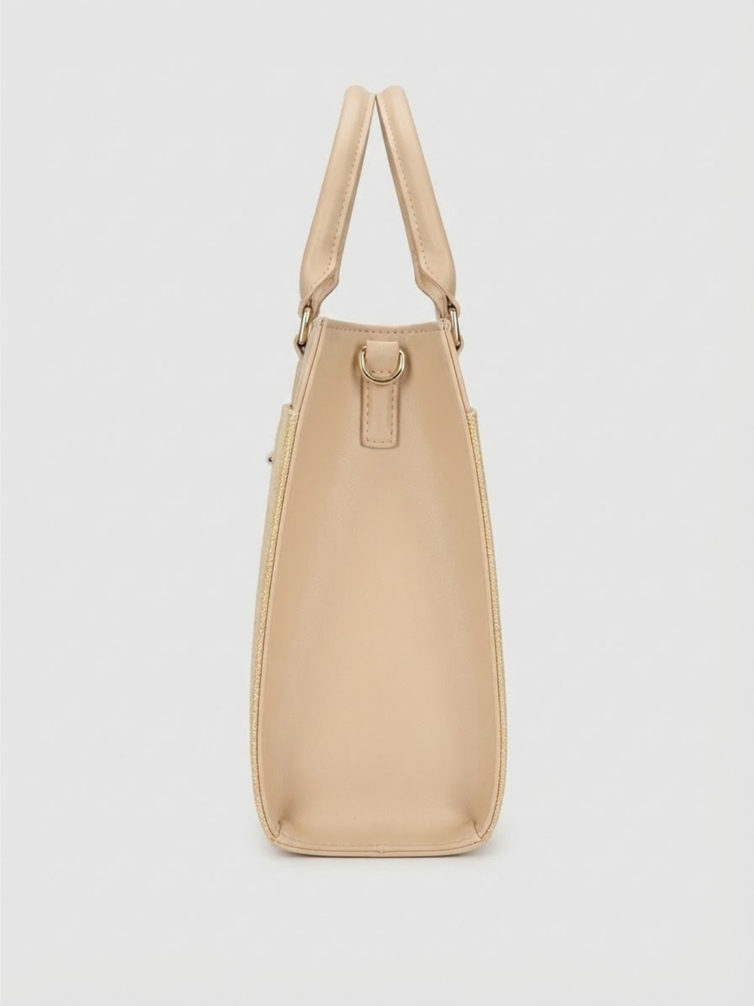 Side profile view of the beige Zaroons London handbag showcasing its structured gusset depth, upright handles, and gold D-ring hardware.
