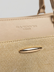 Close-up detail showing the embossed Zaroons London brand logo on beige leatherette and a polished gold-tone hardware embellishment.